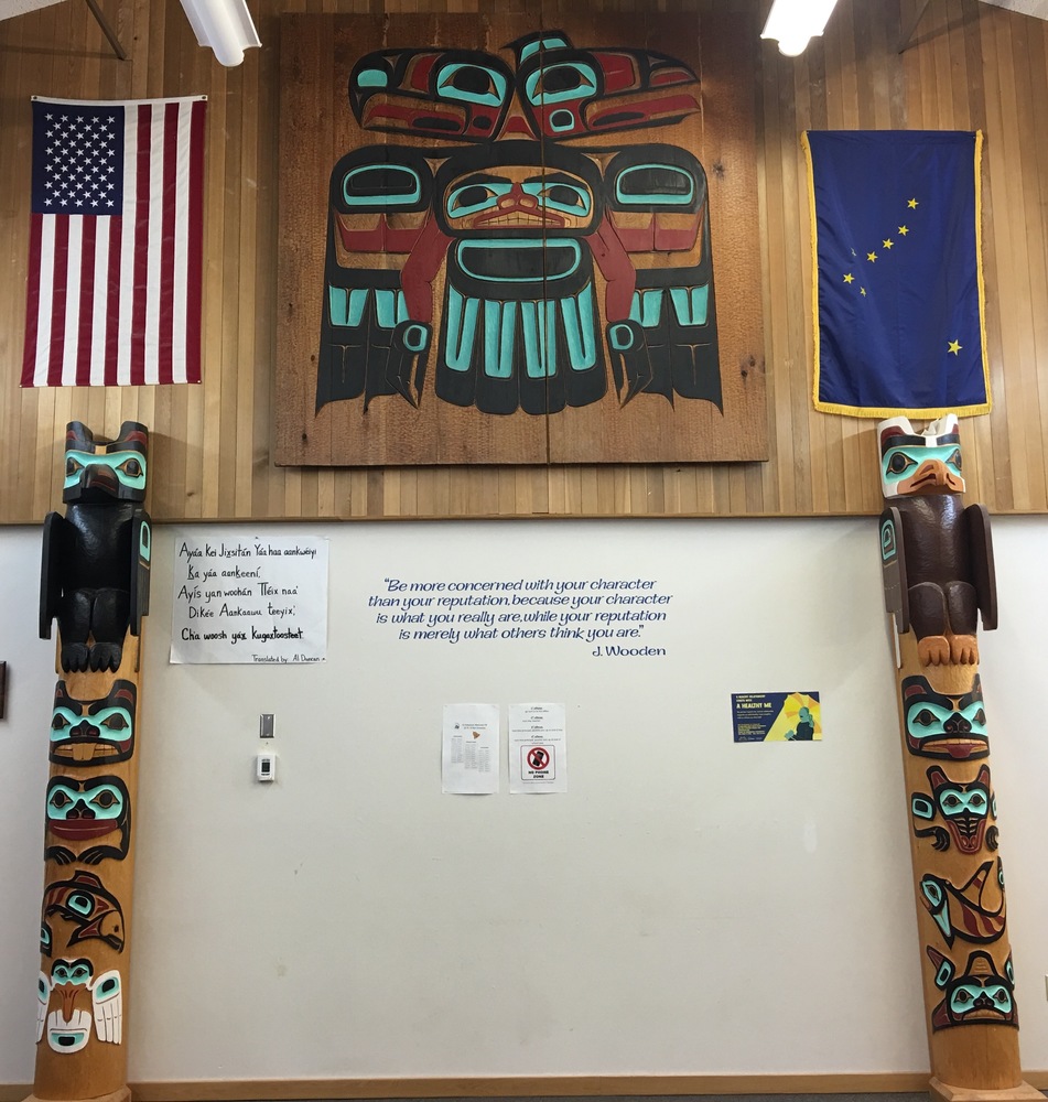 Totem poles, American and Alaska Flags hanging on the wall,