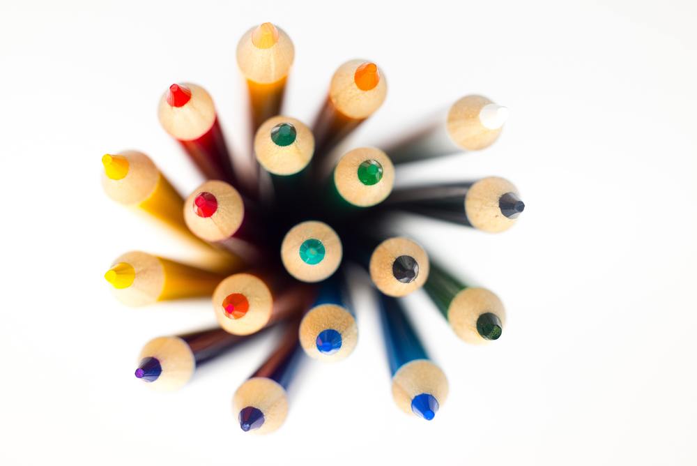 Colored pencils in a swirl with the tips pointed strait up at the camera