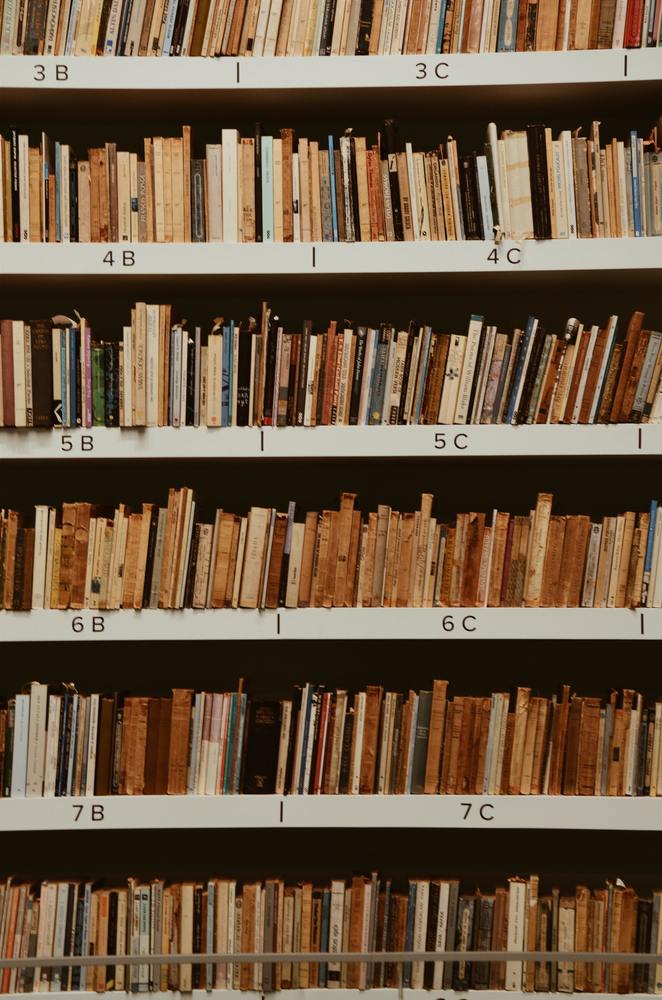 A book shelf with six rows packed full of books
