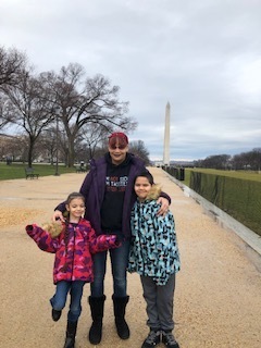 A mom with her daughter and son in front of the Washington Monument