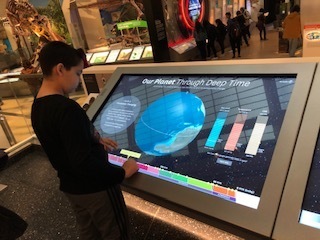 Boy looking at screen of earth