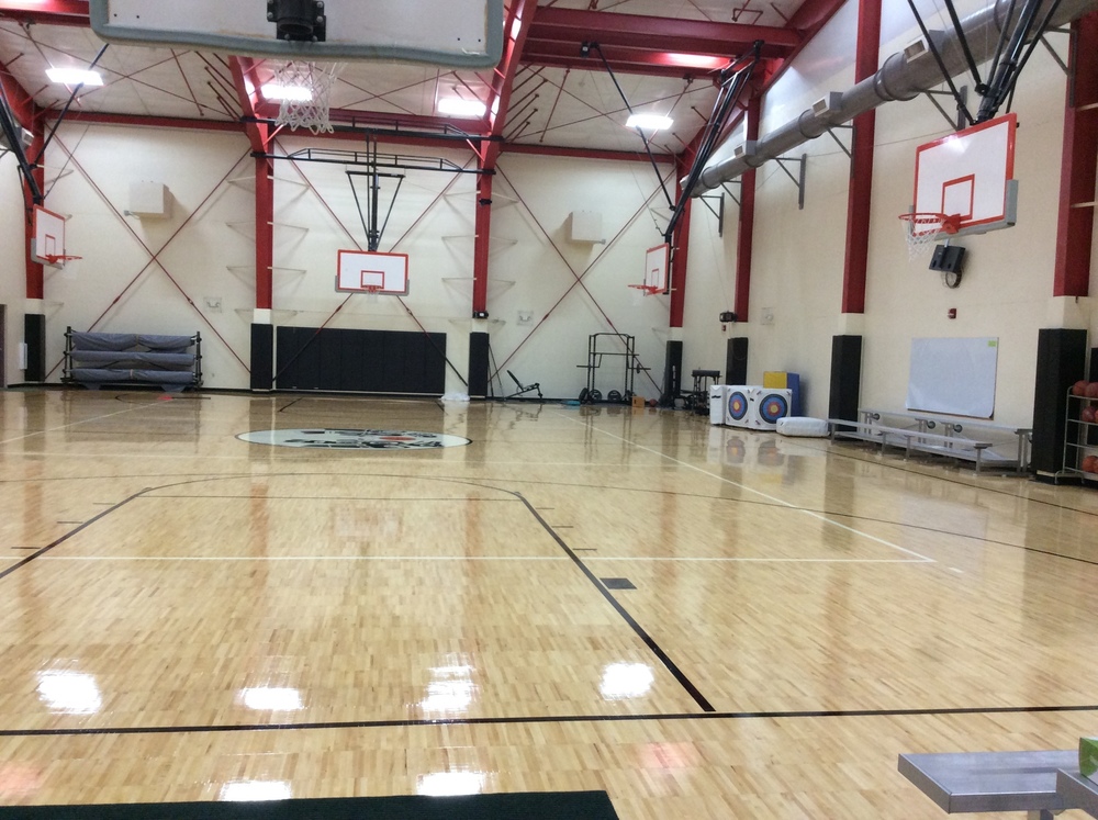 Picture of inside of Klukwan School gym with basketball hoops and bleachers